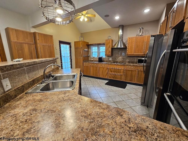 kitchen featuring light tile floors, wall chimney range hood, ceiling fan, backsplash, and sink