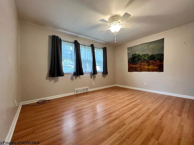 spare room with ceiling fan and light hardwood / wood-style floors