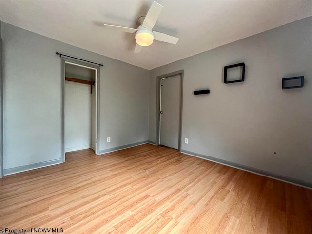 unfurnished bedroom featuring ceiling fan and light hardwood / wood-style floors