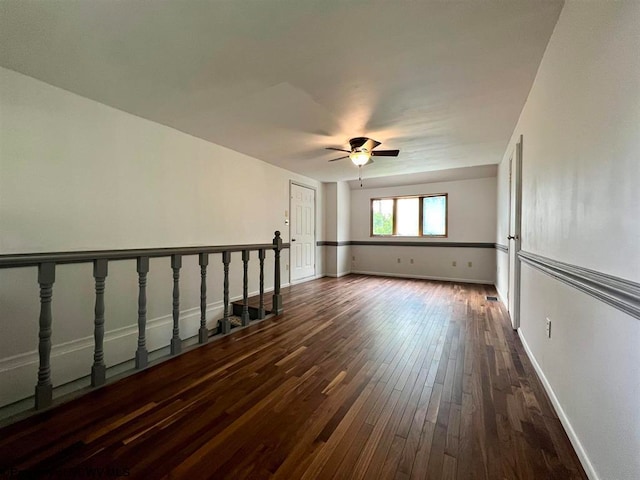 empty room featuring dark hardwood / wood-style floors and ceiling fan