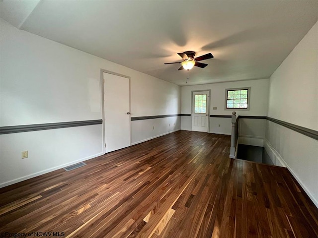 spare room featuring ceiling fan and dark hardwood / wood-style floors