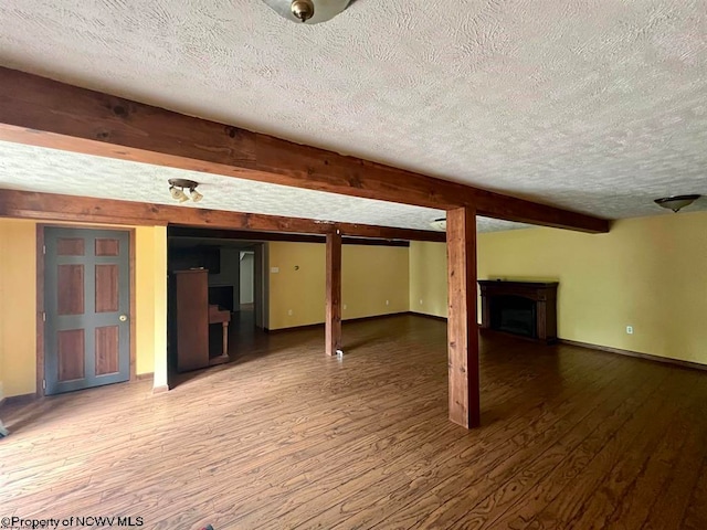 basement featuring a textured ceiling and hardwood / wood-style flooring