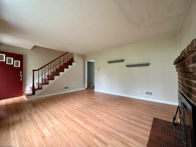 unfurnished living room with light hardwood / wood-style floors and a fireplace