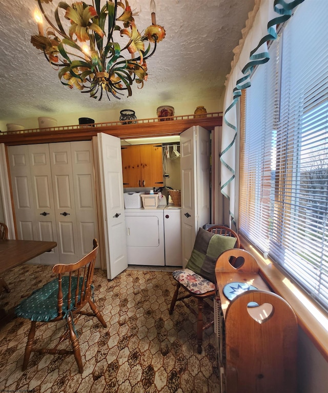 living area featuring light tile flooring, a textured ceiling, a healthy amount of sunlight, and independent washer and dryer