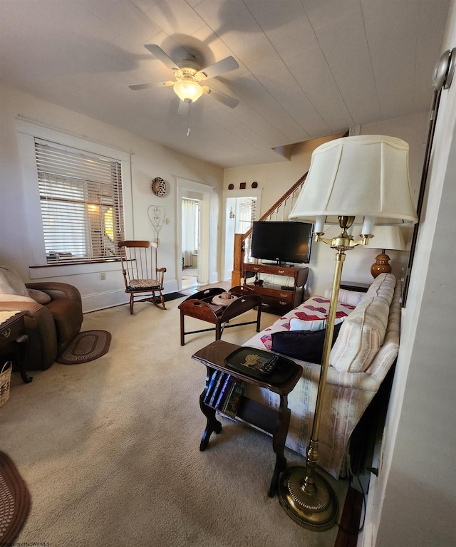 living room featuring ceiling fan and carpet