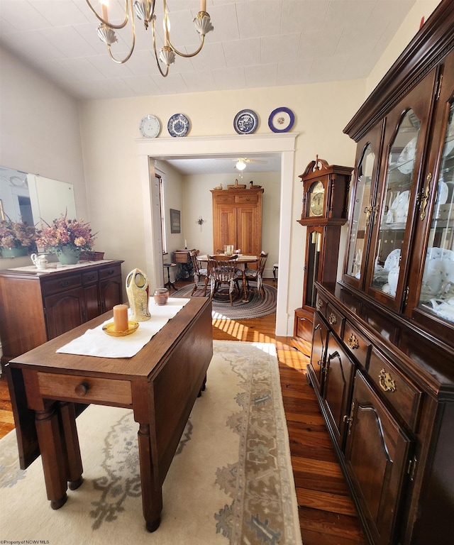 dining area with a notable chandelier and light hardwood / wood-style flooring