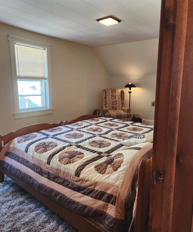 carpeted bedroom with vaulted ceiling