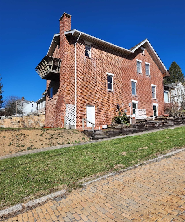 view of property exterior with a lawn