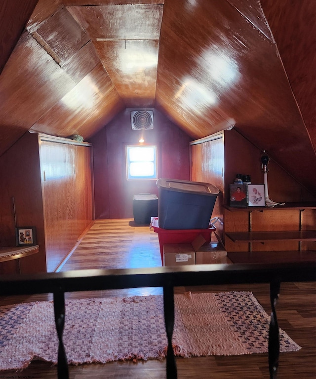 interior space with vaulted ceiling and dark wood-type flooring