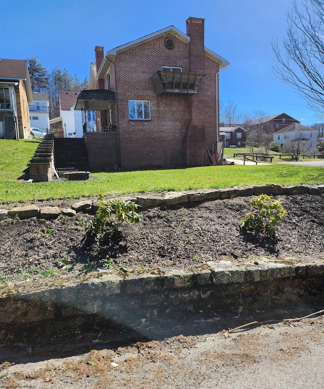 view of side of home featuring a lawn