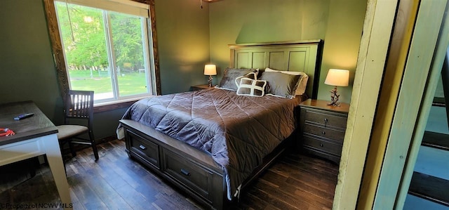 bedroom with dark hardwood / wood-style floors