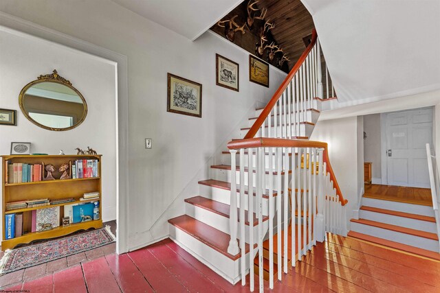 stairway with dark hardwood / wood-style flooring