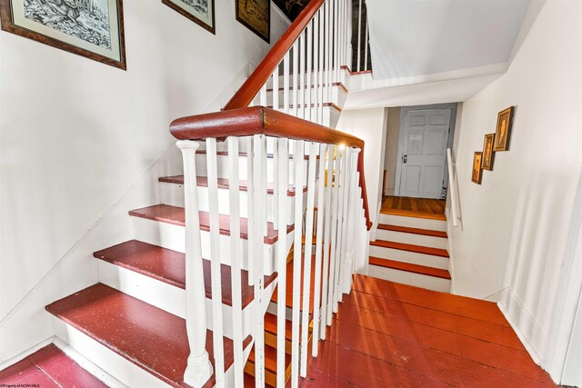 staircase featuring dark wood-type flooring