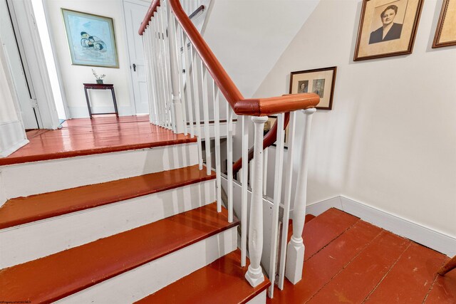 staircase with hardwood / wood-style floors