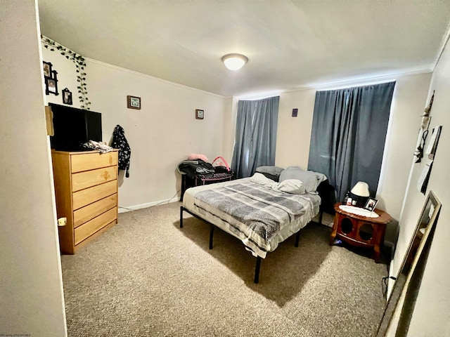 bedroom with crown molding and light colored carpet