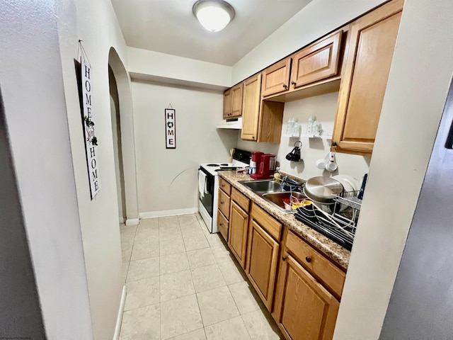 kitchen featuring fume extractor, light tile floors, sink, and electric range