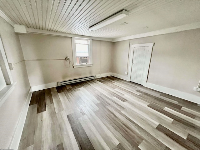 empty room featuring light wood-type flooring and a baseboard radiator