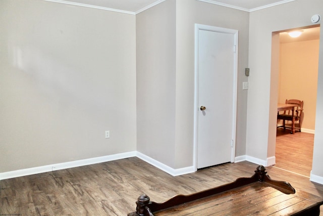 interior space featuring ornamental molding and dark wood-type flooring