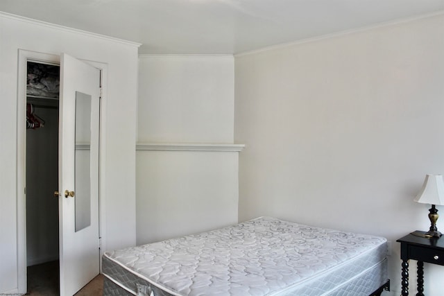 bedroom featuring a closet and crown molding