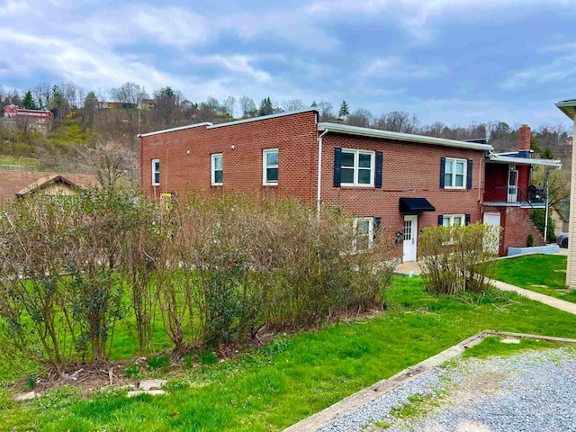 view of property exterior with a yard