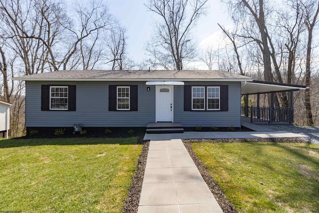 view of front facade with a front yard and a carport