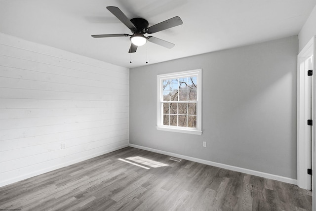 spare room featuring dark hardwood / wood-style flooring and ceiling fan