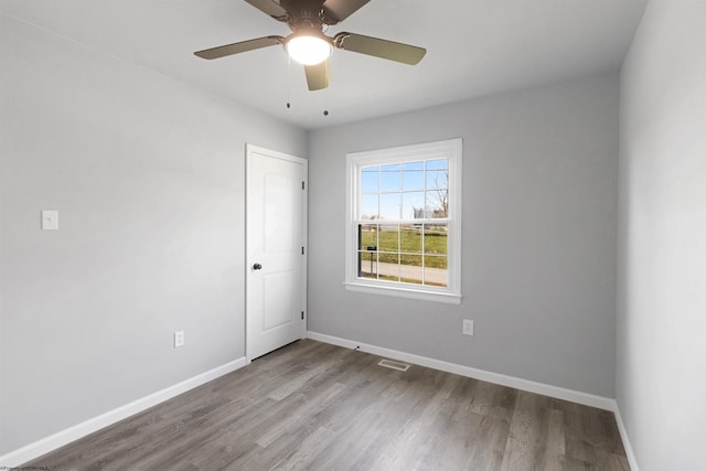 spare room with ceiling fan and light wood-type flooring