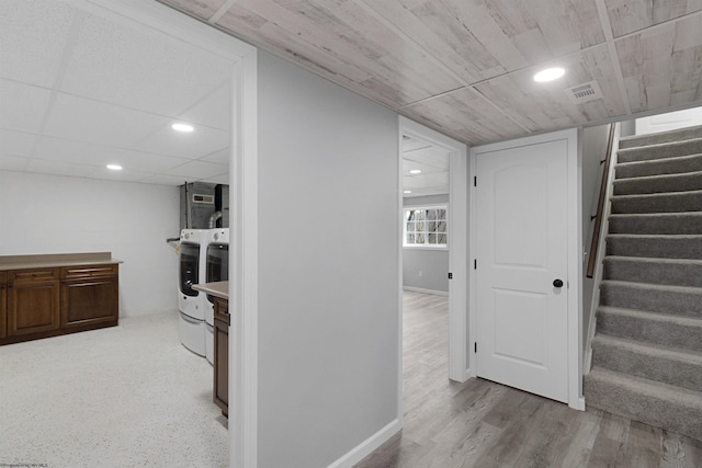 interior space featuring washing machine and dryer and light hardwood / wood-style floors