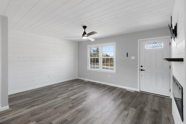 entryway with ceiling fan, dark hardwood / wood-style floors, and wooden ceiling