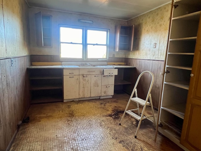 kitchen featuring sink and dark tile flooring