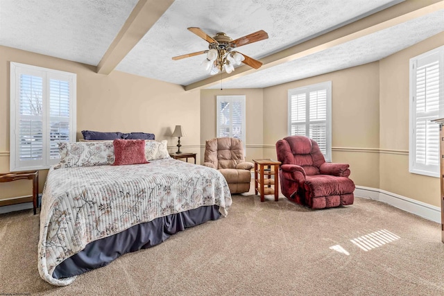 bedroom featuring beam ceiling, a textured ceiling, carpet flooring, and ceiling fan