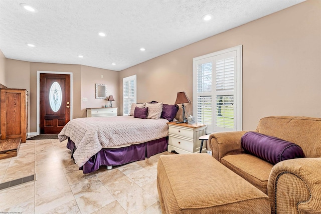 tiled bedroom featuring a textured ceiling