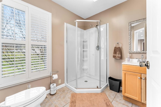 bathroom with a shower with door, tile floors, toilet, and vanity