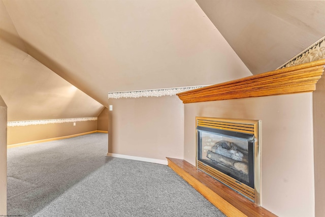 interior space with vaulted ceiling and carpet