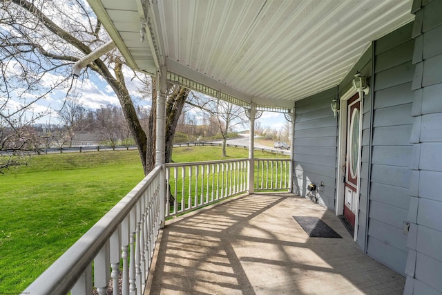 wooden deck featuring a lawn