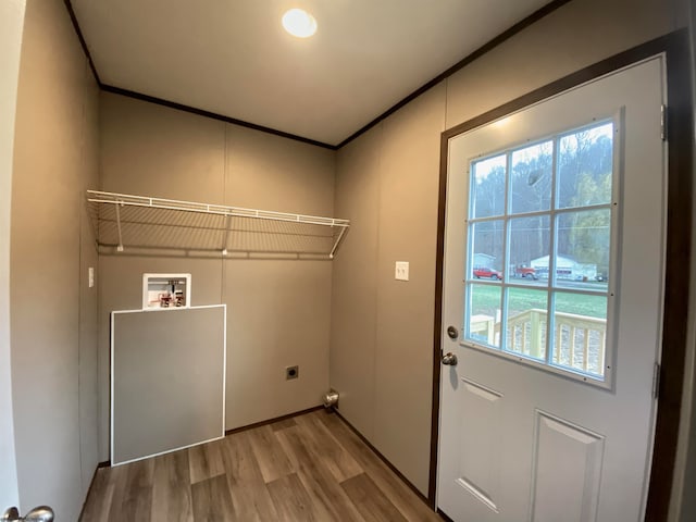 clothes washing area with washer hookup, hookup for an electric dryer, and light hardwood / wood-style flooring