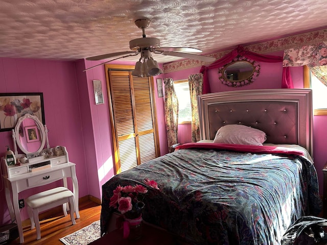 bedroom with multiple windows, a closet, ceiling fan, and a textured ceiling