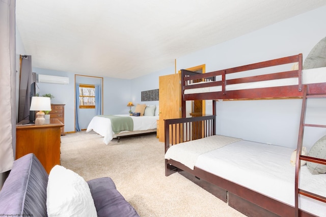 bedroom featuring a wall unit AC and light colored carpet