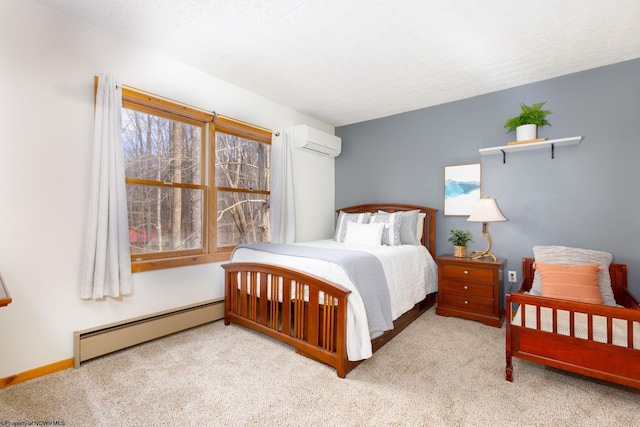 carpeted bedroom featuring a baseboard radiator and an AC wall unit