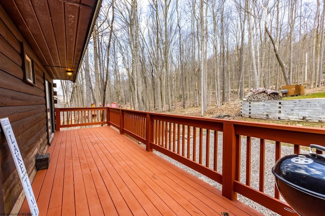 wooden deck featuring a grill