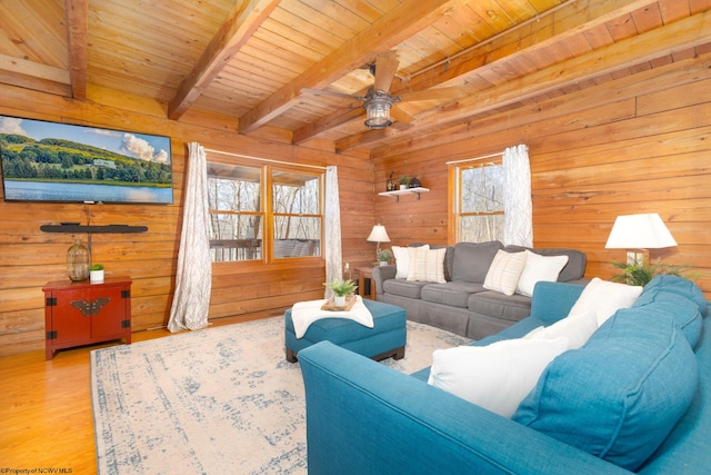 living room with plenty of natural light, beam ceiling, and wood ceiling