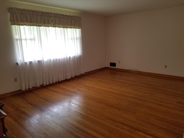 empty room featuring wood-type flooring