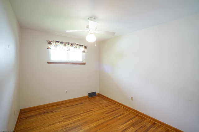 empty room featuring ceiling fan and light hardwood / wood-style floors