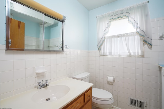 bathroom with backsplash, tile walls, toilet, and vanity