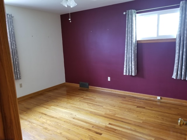 spare room with ceiling fan and light hardwood / wood-style flooring