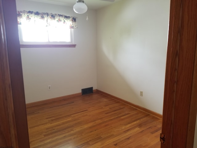 spare room with wood-type flooring