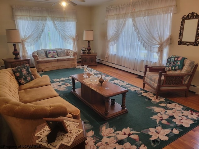 living room featuring ceiling fan, hardwood / wood-style flooring, and a baseboard radiator