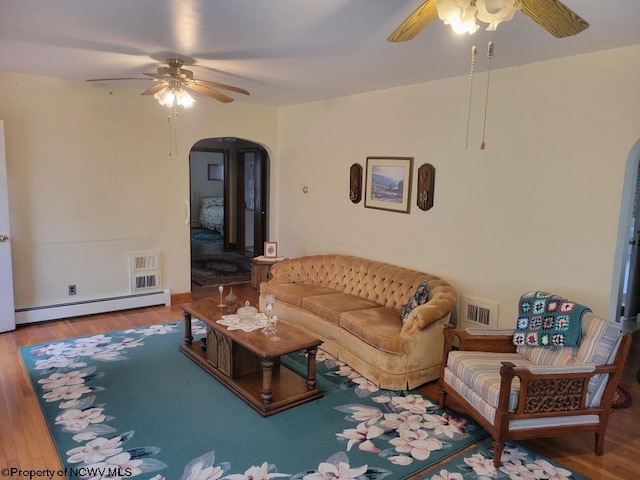 living room with wood-type flooring, ceiling fan, and a baseboard radiator