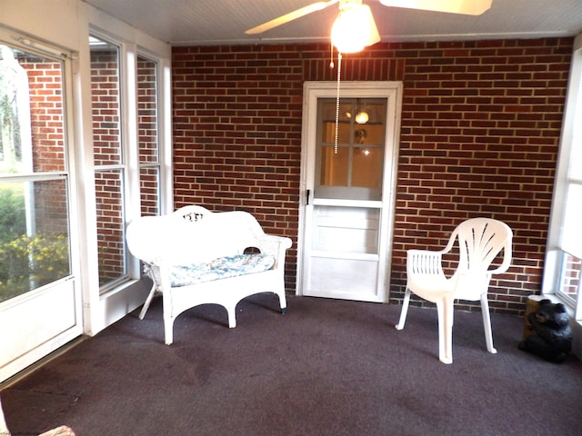 sunroom with ceiling fan and a wealth of natural light