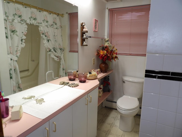 bathroom featuring toilet, vanity, baseboard heating, and tile floors